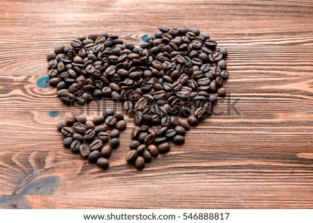 Coffee beans, grain two hearts on background of sacking, bagging. Valentine's Day or Wedding