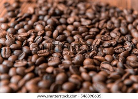 a large amount of coffee beans on a wood background