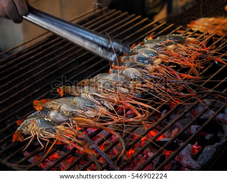 Grilled shrimps on the flaming grill, In Thailand market. Selective focus on Shrimp
