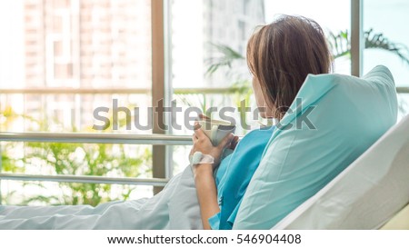 illness asia patient women and hospital concept - illness asian patient women on bed seeing windows in room alone of hospital and copyspace Royalty-Free Stock Photo #546904408