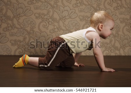 little boy crawling on the floor