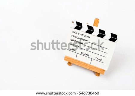 White Clapperboard on reading desk isolate