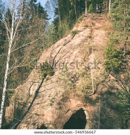 ancient sandstone cliffs with inscriptions in the Gaujas National Park, Latvia - instant vintage square photo