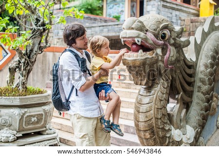 Happy tourists dad and son in Long Son Pagoda. Travel to Asia concept. Traveling with a baby concept.