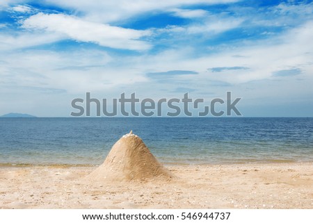 Beautiful tropical beach and sea with white sand castle,cloud and blue sky background