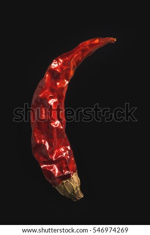 Dry chili pepper on isolated black background close-up Royalty-Free Stock Photo #546974269