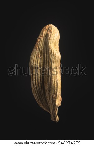 Cardamom seed on isolated black background close-up Royalty-Free Stock Photo #546974275