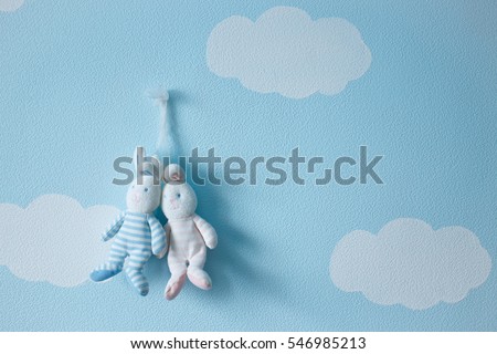Romantic couple of love rabbits toy against the background of clouds and sky