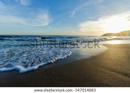 Sunset on beach Royalty-Free Stock Photo #547014883