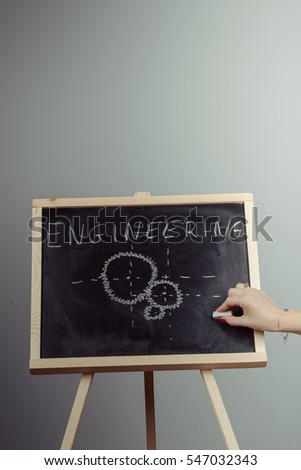 Engineering word handwritten on chalkboard. Gray background
