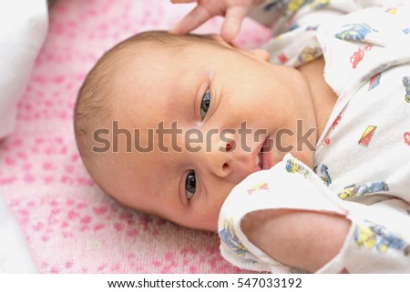Cute newborn baby lying in the bed. Stock photo