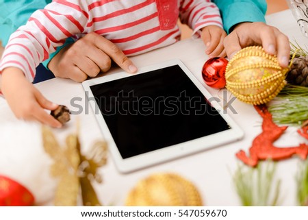 Father with child having fun using wireless technology playing watching media on digital tablet. Top view mockup display closeup festive background