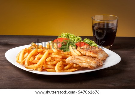fish and chips with lettuce and tomato Royalty-Free Stock Photo #547062676