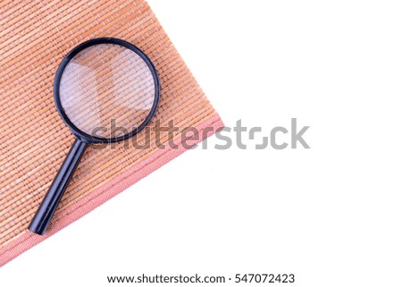 Magnifying glass on brown cover with white background