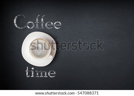 coffee time. cup of coffee on the table and an inscription coffee time. the view of the top of the cup of coffee on a dark background 