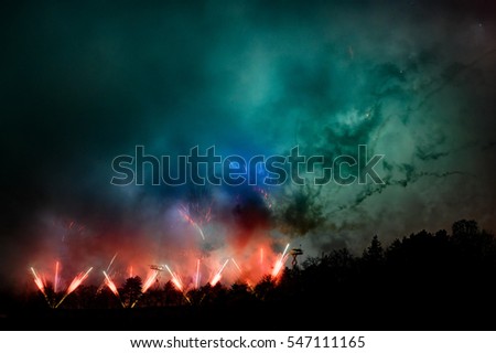 Big dramatic fireworks scene with green clouds and red fire