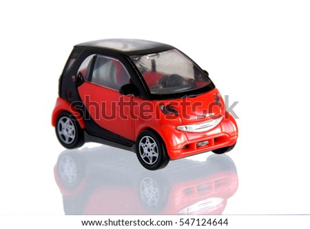 Small red toy car isolated on white with reflection