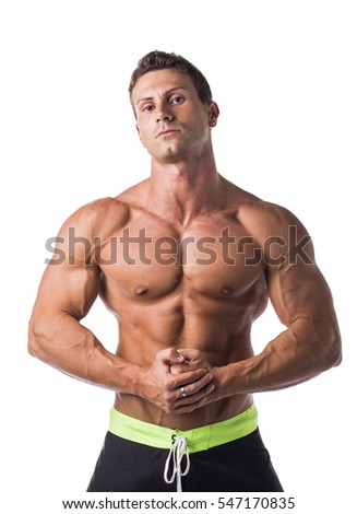 Handsome shirtless bodybuilder looking at camera, isolated on white background