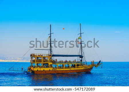 Sailing ship with tourists on a background of blue sky and sea in Alanya, Turkey