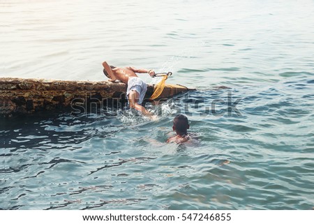 Young boys swimming on the beach