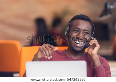 Customer Service agent in an startup office with laptop Royalty-Free Stock Photo #547263550