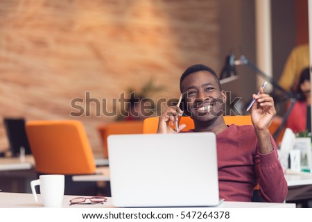 African American businessman sitting at the computer in startup office Royalty-Free Stock Photo #547264378