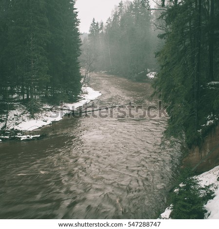 scenic winter colored river in country with snow and trees - instant vintage square photo