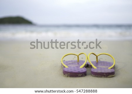 one sandal shoe on sand beach