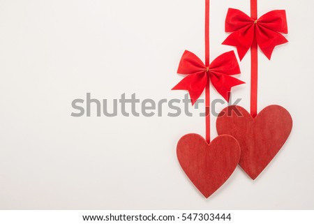 Decorative red bow and heart on a white background