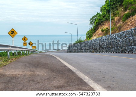 Road on seaside and street sign in Thailand