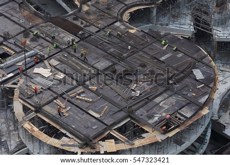 Workers at a construction site  Royalty-Free Stock Photo #547323421