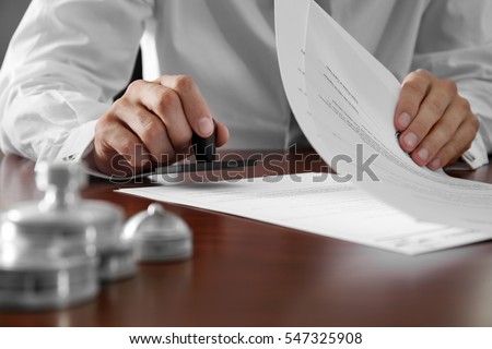Notary public in office stamping documents Royalty-Free Stock Photo #547325908