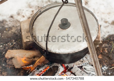 A delicious soup made from fresh fish brewed in a pot on an open fire of wood