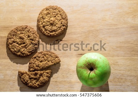 Oatmeal cookies on a wooden board with green apple. Flat lay Royalty-Free Stock Photo #547375606