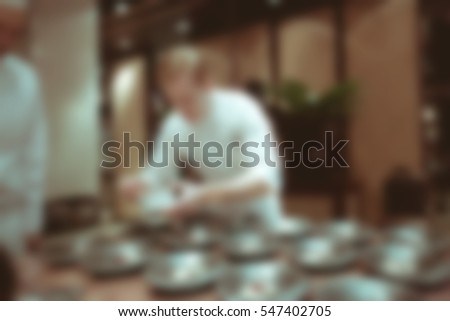 Blurry background vintage color style of Chef in hotel or restaurant kitchen cooking for luxury dinner party.