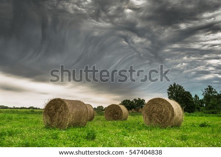 Harvest and stormy clouds