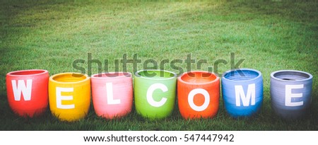 Welcoming and greetings concept with welcome word colorful on garden backgroun