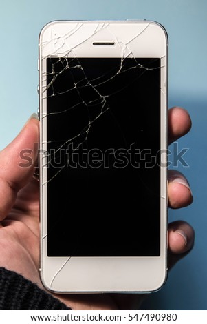 Broken phone in a hand, black screen