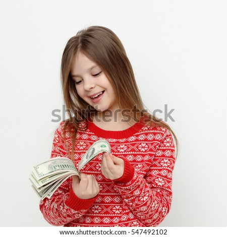 Pretty teen girl holding cash money USA dollars