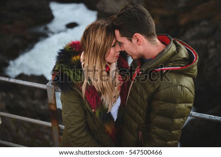 couple looking into eyes of each other over river