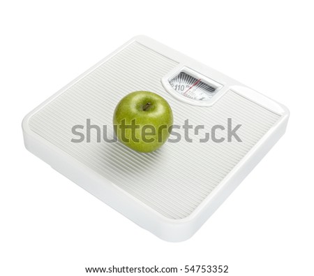 close up of scale and apple on white background with clipping path