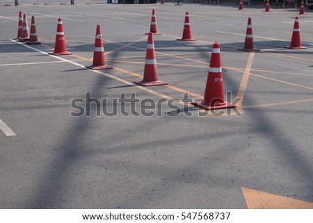 orange traffic cones in outdoor parking lot
