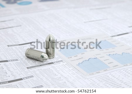 Two metal Bullets on a News paper Stock market financial page showing stocks and shares