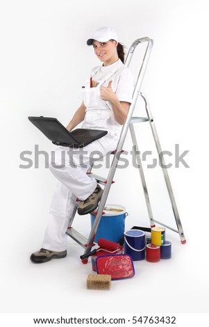 Portrait of a painter leaning on a ladder with a laptop computer