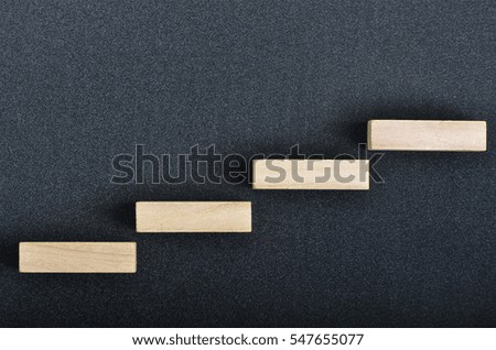 A square wooden block arrange on top of black background