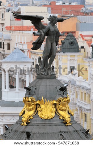 Sculpture on the roof of historical Metropolis Building, located at Gran Via main shopping street in Madrid, Spain. 