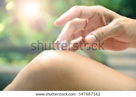 The woman put the analgesic balm on knee Royalty-Free Stock Photo #547687162