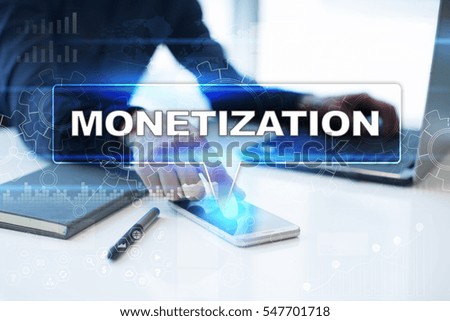 Businessman working in office, pressing button on virtual screen and selecting monetization.
