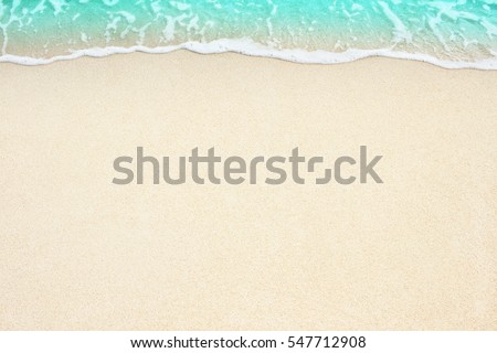 Soft beautiful ocean wave on sandy beach. Background.