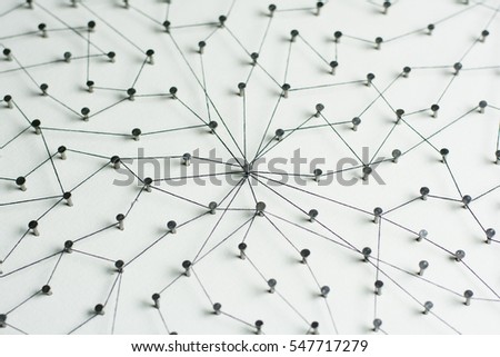 Linking entities, Network simulation, social media, Communications Network, The connection between the two networks. in paper linked together by cotton with a black yarn